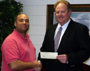 Jorge Benitez receives check from Jeffrey Murphy