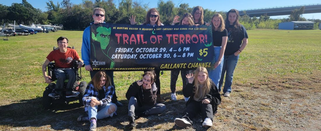 Group holding Boo-fort sign