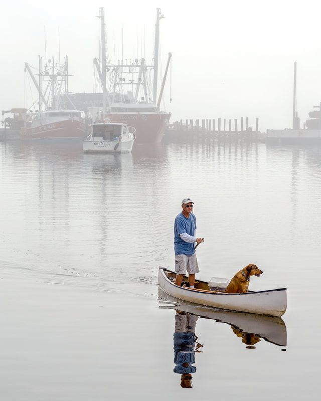 Photo of a man and dog in canoe - "Canoe Buddies" by Rick Gourly