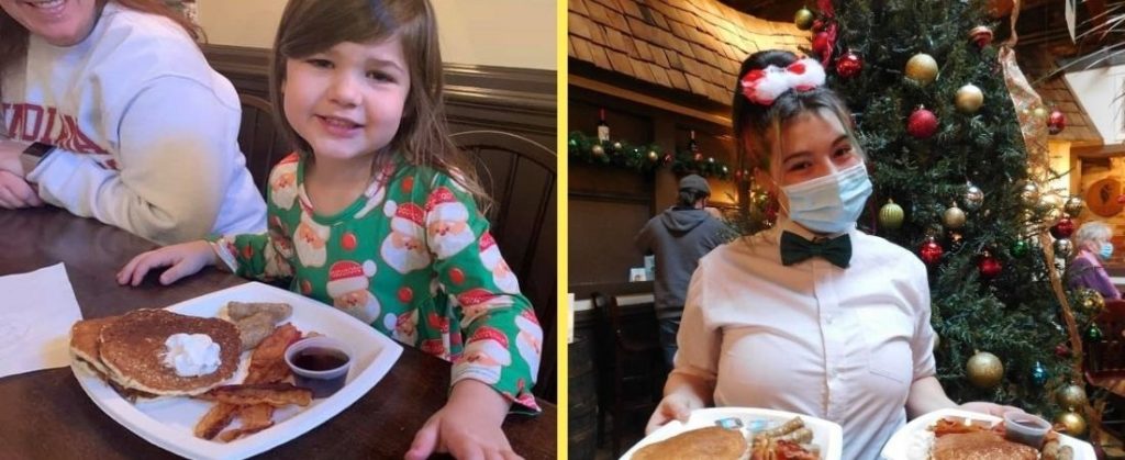 Young girl smiling eating pancakes and waitress by Christmas tree