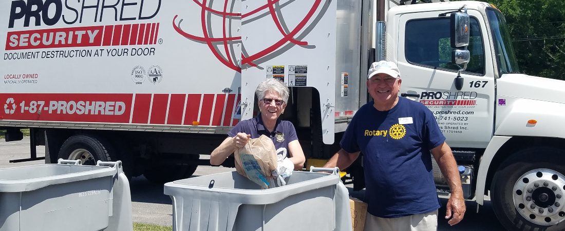 Barbara Belon & Mitch Khoury in front of shredding bins