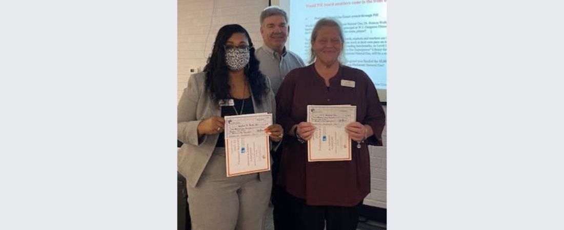Dr. Roneca Wallace, principal at Graham A. Barden Elementary, and Debra Hurst, principal at W.J. Gurganus Elementary receiving their awarding from PIE past president, Don Brinkley