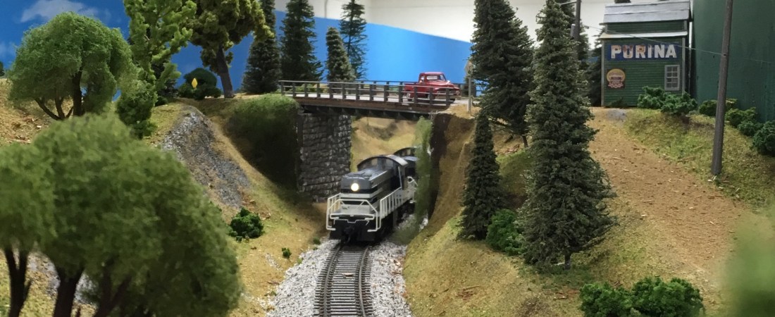 Model railroad, train going under bridge