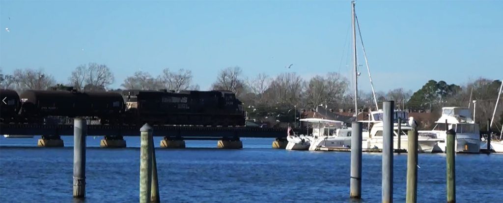 Norfolk Southern Railroad Train rides over Trent River Bridge in New Bern NC