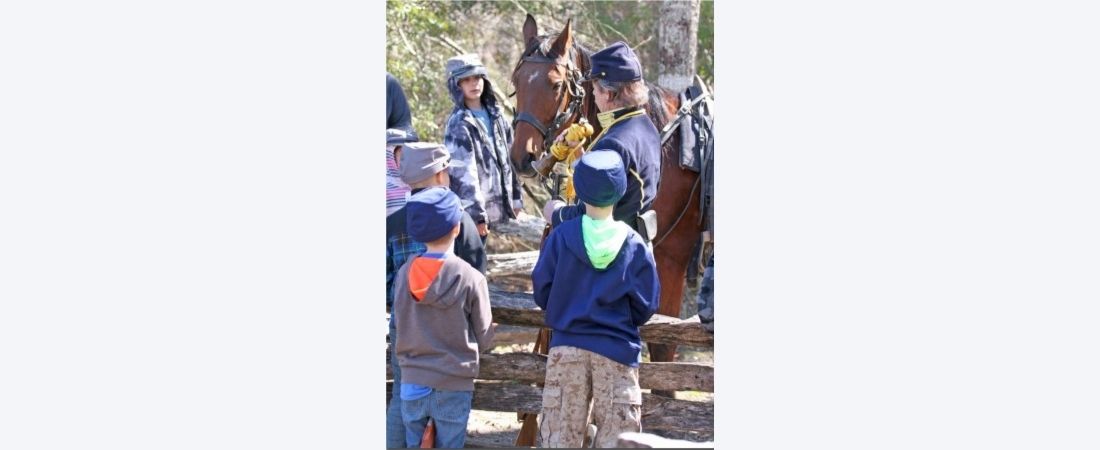 Cavalry with children at enactment camp