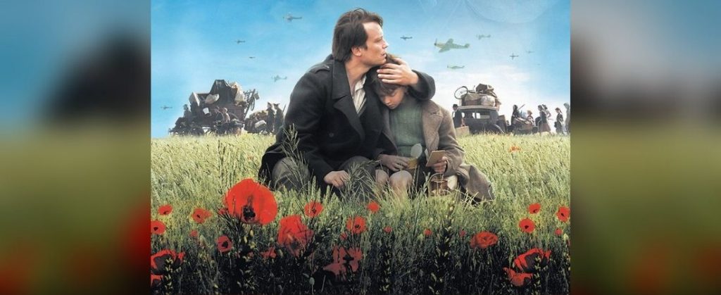 Man hugging boy in poppy field