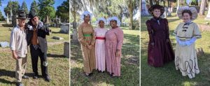 Women and men in cemetery in 1800s clothing