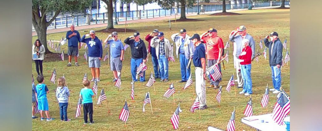 Students join Vietnam Veterans Chapter 886 members to place flags at Union Point Park in preparation for Veterans Day (photo by Steven Smith)