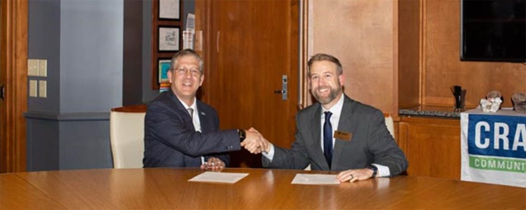 Craven CC President Dr. Ray Staats, left, and NC Wesleyan University President Dr. Evan D. Duff sign a new agreement that provides discounted tuition rates for Craven CC employees.