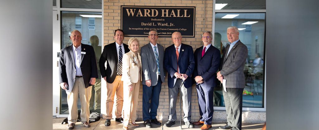 David L. Ward, Jr. is honored with an unveiling of the new signage for Ward Hall during a dedication ceremony on Feb. 21. The longtime Craven CC supporter served as the college's general counsel for over 51 years. Pictured L-R: Craven CC Trustee Bill Taylor, Trustee Chair Whit Whitley, past Trustee Carol Mattocks, Craven CC President Dr. Ray Staats, David Ward, past Craven CC President Scott Ralls, and Trustee Kevin Roberts.