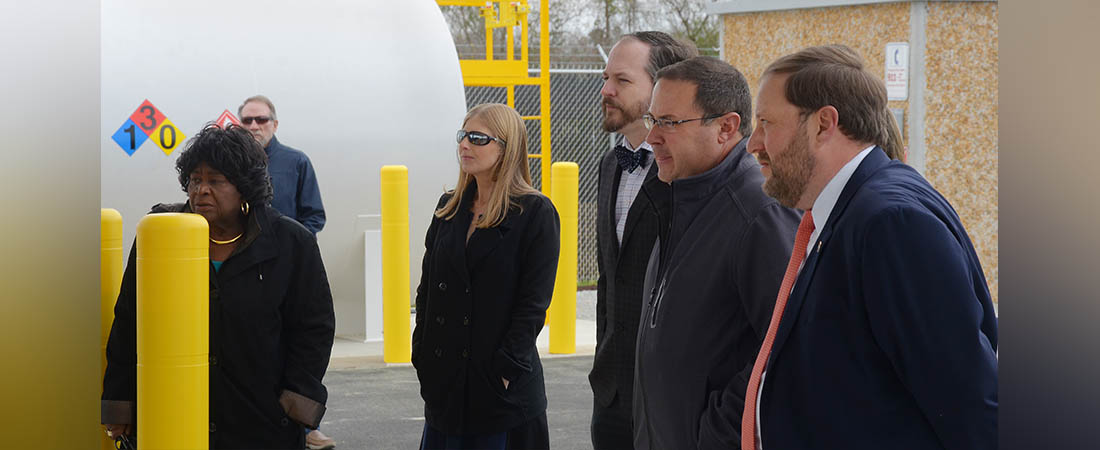 Craven County Commissioners Beatrice Smith, Chadwick Howard and Jason Jones, join County Manager Jack Veit and Lauren Wargo, assistant to the county manager, during the ribbon cutting ceremony for the county's new fueling station.