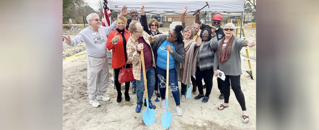 Members of the Habitat for Humanity of Craven County Board of Directors and volunteers join Marc Thomas and Venola Dillahunt during a Feb. 20 groundbreaking ceremony for their new homes in New Bern's Pembroke Community. Photo by Todd Wetherington.