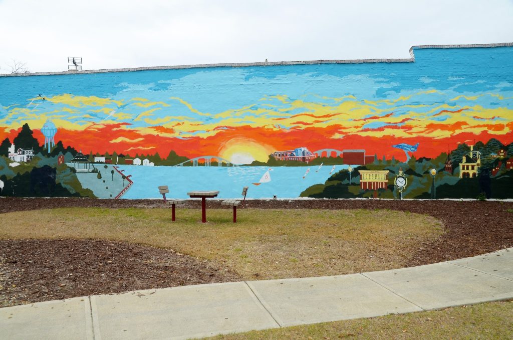A sunset mural decorates a wall in New Bern's Five Points district painted by Derrick Bryant. Photo by Todd Wetherington.