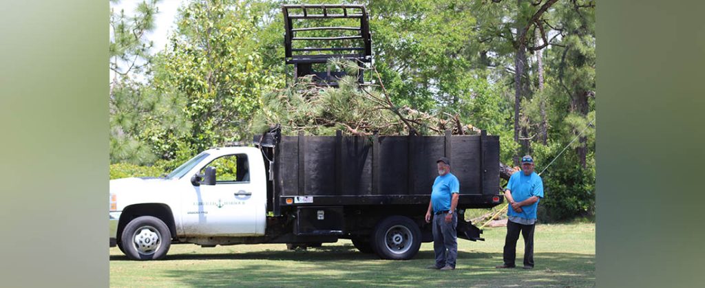 Steven Smith and "Bear" were part of a crew removing fallen trees in Fairfield Harbour. Photo by Wendy Card.