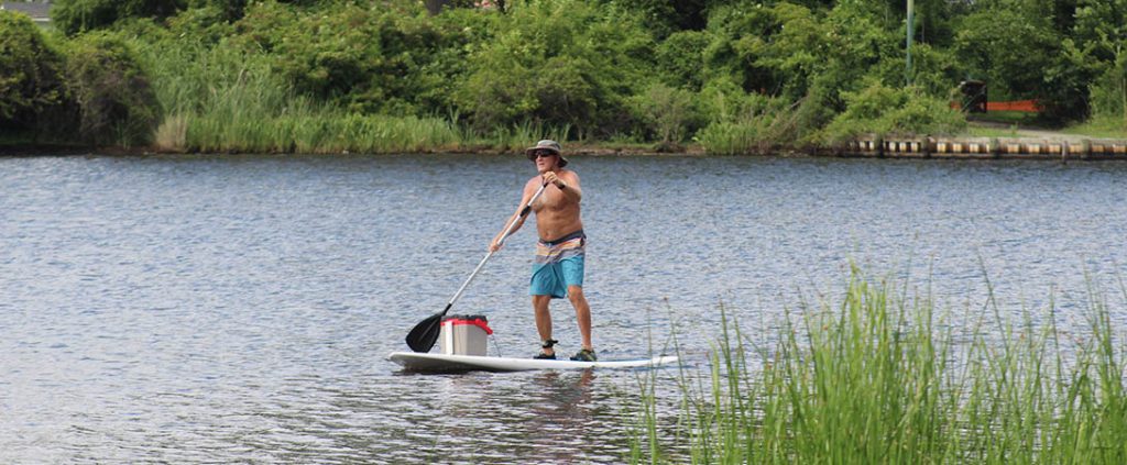 Brad Wells paddleboarding on the Trent River.