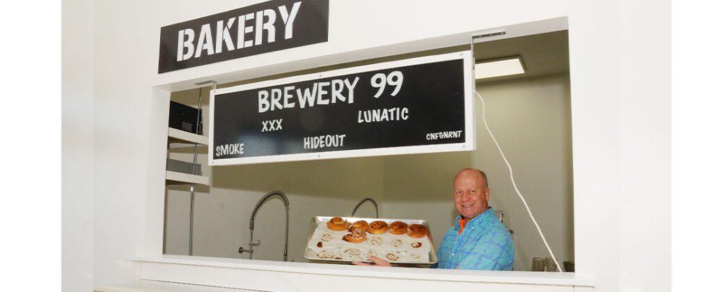 Brewery 99 owner Pete Frey shows off a tray of cinnamon rolls prepared at the businesses newly opened bakery.