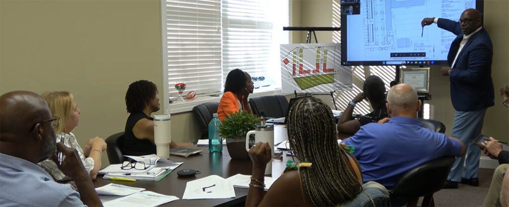 Reginal Barner presents a concept drawing of the FR Danyus project plan to the NBHA Commissioners Ronald Scott, Sabrina Bengel, Denise Powell, Jennell Reddick, Dana Outlaw and James Copland during the meeting on Aug. 19, 2024. (Photo by Wendy Card)