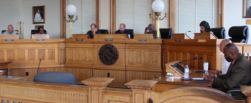 Photo of Alderman Rick Prill, Hazel Royal, Bobby Aster, Mayor Jeffrey Odham, Alderman Barbara Best, City Attorney Scott Davis and Asst. City Manager Marvin Williams in the courtroom at city hall in downtown New Bern taken on Aug. 2, 2024. (Photo by Wendy Card)