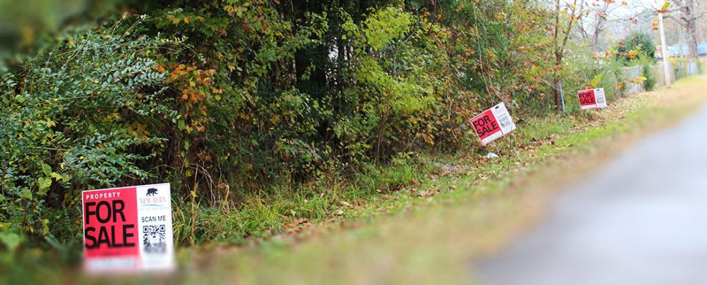 "Property for sale" signs in the city of New Bern's redevelopment zone. (Photo by Wendy Card)