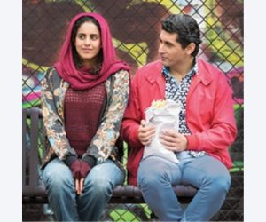 woman and man sitting on bench