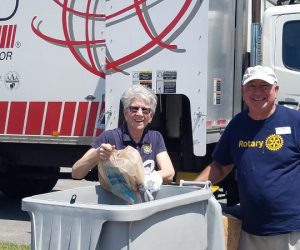Barbara Belon & Mitch Khoury in front of shredding bins