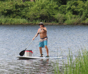 Brad Wells paddleboarding on the Trent River.