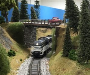 Model railroad, train going under bridge