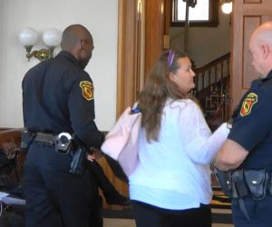 New Bern Citizen being escorted out of Board of Aldermen Meeting