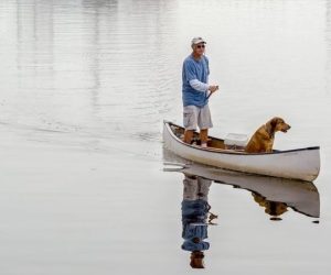 Photo of man and dog in canoe - "Canoe Buddies" by Rick Gourly