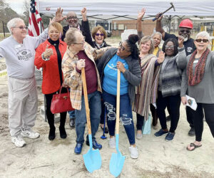 Members of the Habitat for Humanity of Craven County Board of Directors and volunteers join Marc Thomas and Venola Dillahunt during a Feb. 20 groundbreaking ceremony for their new homes in New Bern's Pembroke Community. Photo by Todd Wetherington.