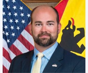 Jeffrey Odham in front of US Flag and New Bern flag