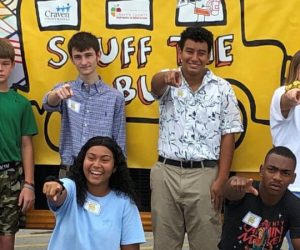 Kids and Teachers in front of bright yellow Stuff the Bus bus