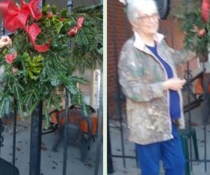 Women decorating Bishop House with red bows and garland