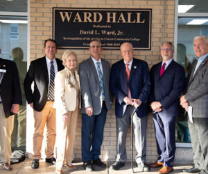 David L. Ward, Jr. is honored with an unveiling of the new signage for Ward Hall during a dedication ceremony on Feb. 21. The longtime Craven CC supporter served as the college's general counsel for over 51 years. Pictured L-R: Craven CC Trustee Bill Taylor, Trustee Chair Whit Whitley, past Trustee Carol Mattocks, Craven CC President Dr. Ray Staats, David Ward, past Craven CC President Scott Ralls, and Trustee Kevin Roberts.